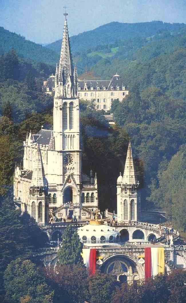 Basilika der Unbefleckten Empfängnis (obere Basilika), erbaut über der Grotte de Massabielle und der ersten Kirche von 1866, der heutigen Krypta, und 1876 geweiht, davor die Rosenkranz</a>-Basilika, im Sanktuarium in Lourdes